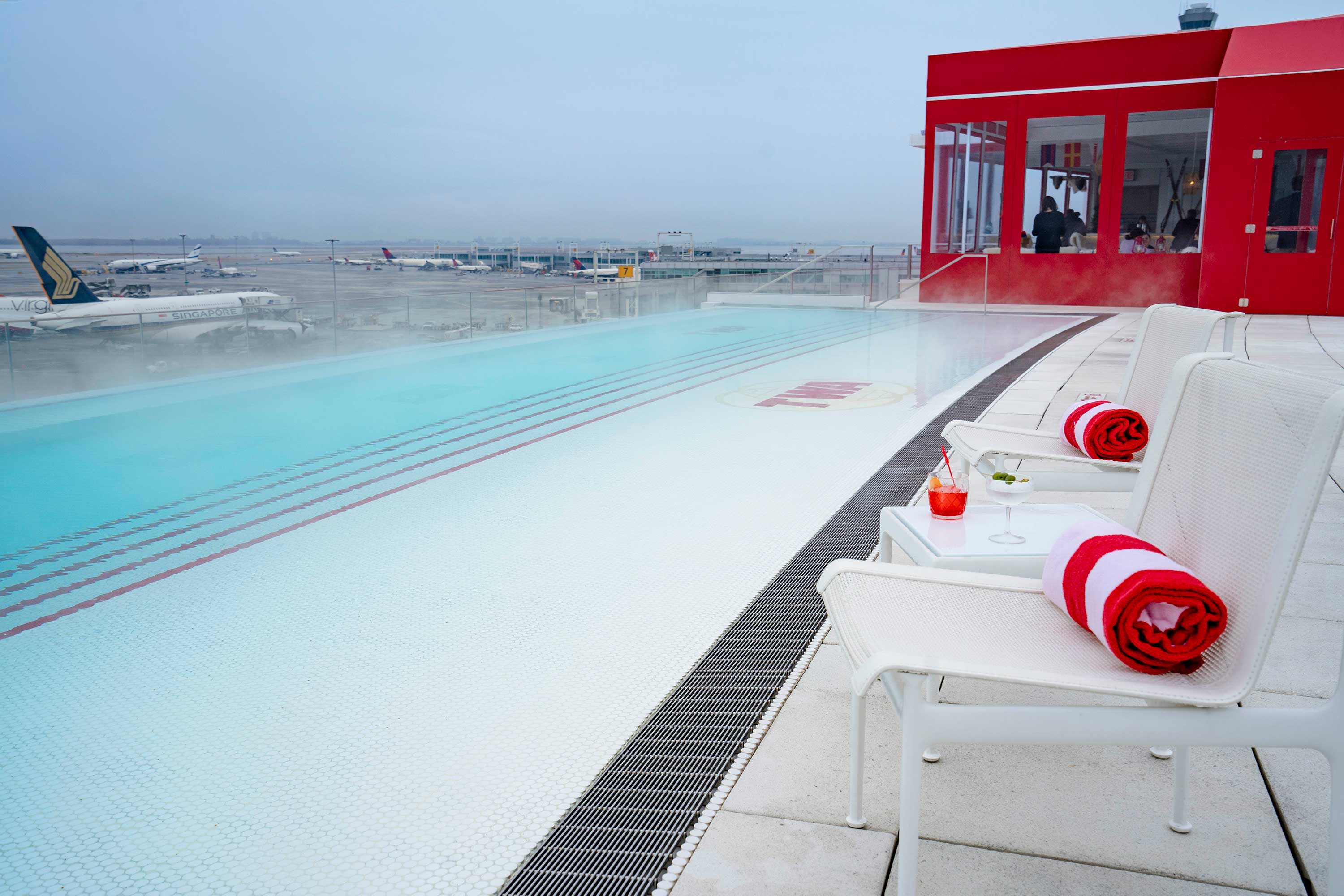 The TWA Hotel rooftop pool overlooks Runway 4L/22R.